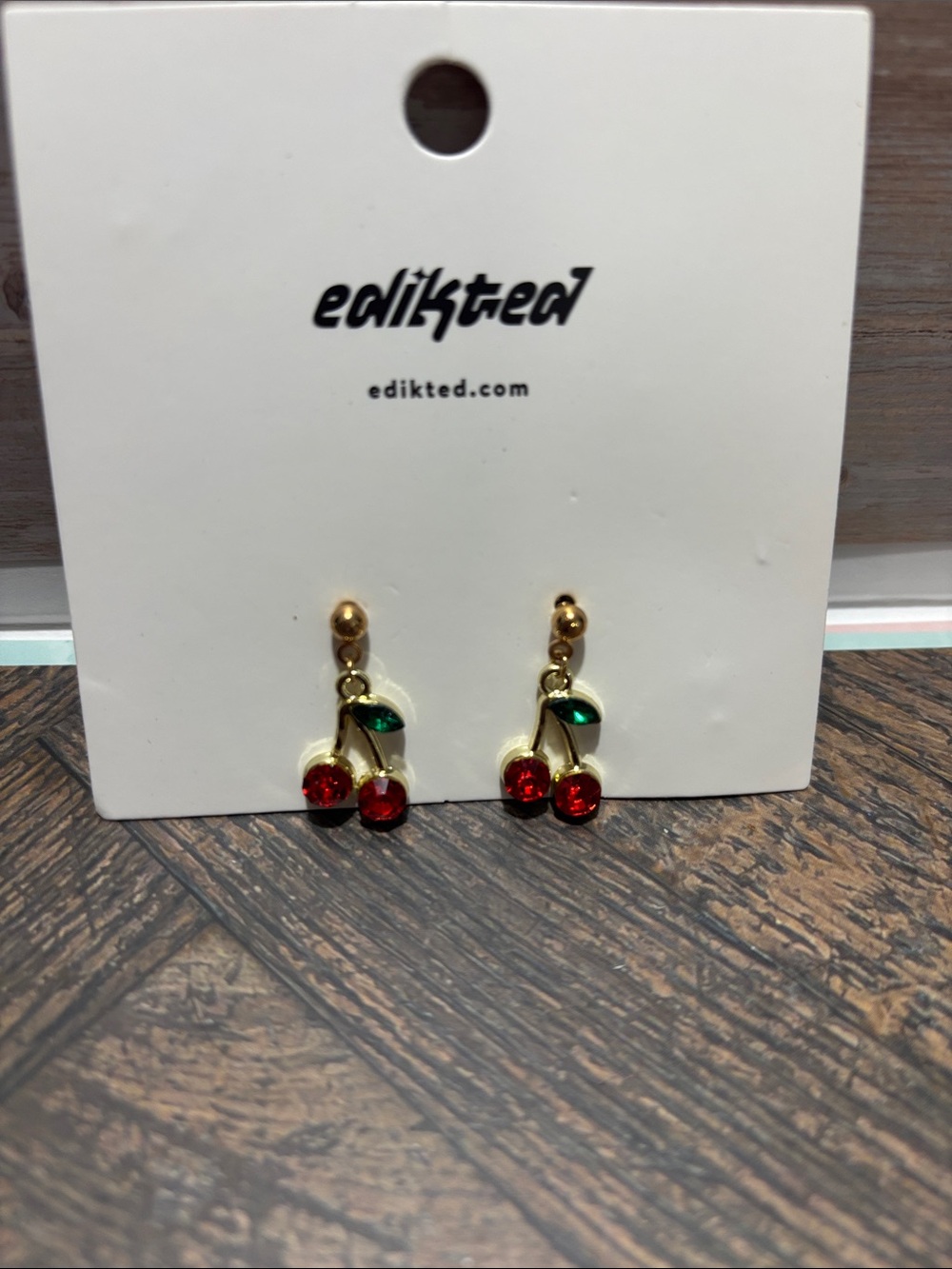 Edikted Gold Cherry Drop Earrings with Red Stones and Green Leaves